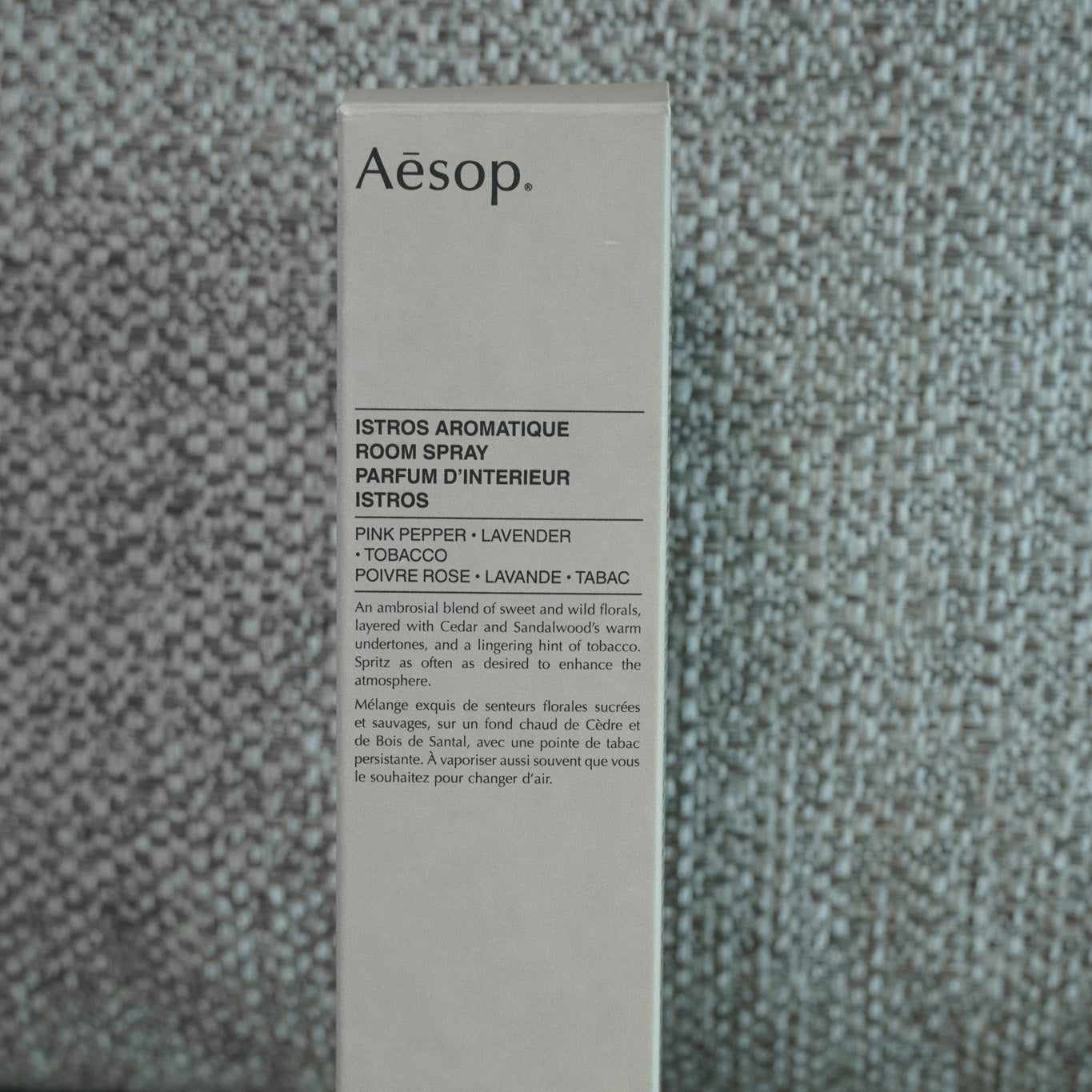 Aesop product packaging on a textured gray background